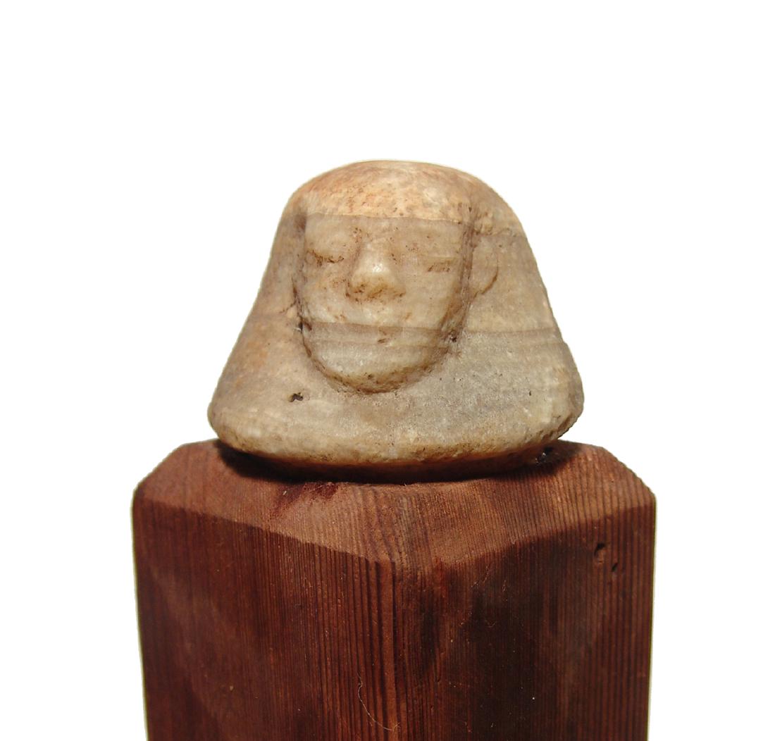 An Egyptian alabaster head canopic from a canopic jar: An Egyptian alabaster head canopic from a canopic jar, Late Period, c. 664 - 332 BC, representing the human-headed canopic deity Imsety, which was one of the 'Sons of Horus' that protected parts of th