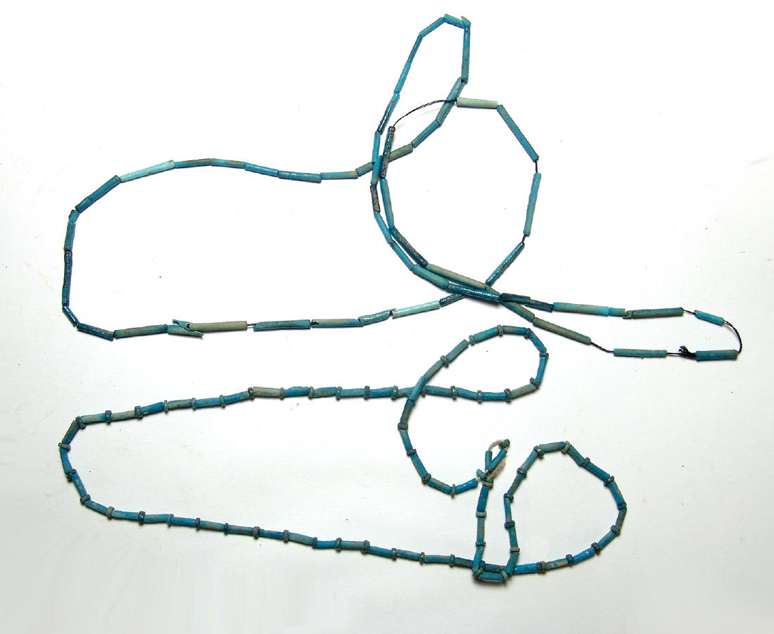 A lovely pair of Egyptian faience beaded necklaces: A lovely pair of Egyptian faience beaded necklaces, Late period, c. 664 - 30 BC, comprised of disk-shaped and tube-shaped beads, all in a deep shade of blue. Both are restrung on modern cord and are n