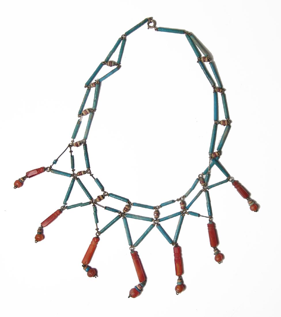 Lovely necklace of Egyptian faience & carnelian beads: A lovely necklace comprised of Egyptian faience and carnelian beads. The beads include lovely translucent carnelian examples, New Kingdom, c. 1570 - 1075 BC, both elongated and rounded as well as faie