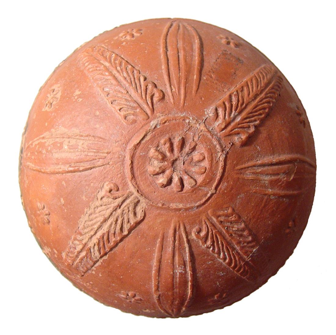 A nice Hellenistic Megarian red-ware bowl: A nice Hellenistic Megarian red-ware bowl, c. 2nd - 1st Century BC, of hemispherical form, the bottom with a beautifully molded central rosette within a circle, radiating petals and palm frond around 