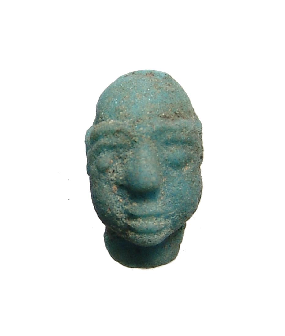 A Phoenician glazed head of a male: A Phoenician glazed head of a male, c. 6th - 4th Century BC, with detailed features and nice blue-green color. 15 x 9 mm. Ex collection of Robert Thompson, Philadelphia, acquired from Mark Reid - the
