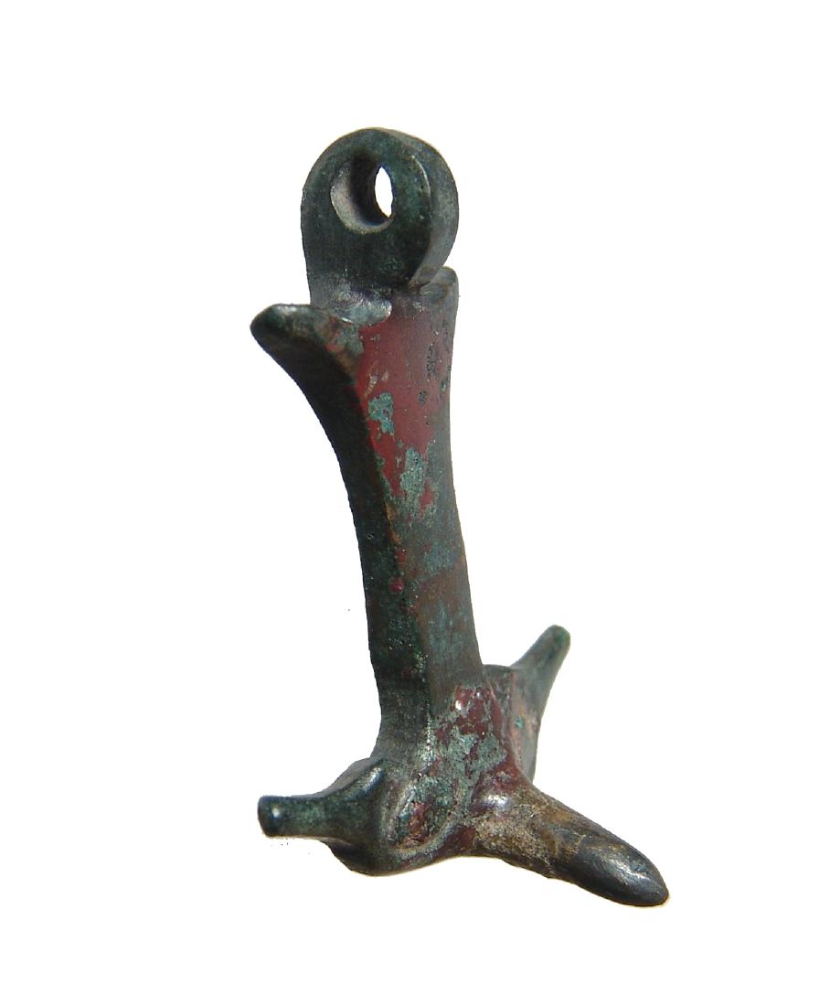 A nice Roman phallic applique: A nice Roman phallic applique, c. 1st - 3rd Century AD, with spiked protrusions on either side and suspension loop at top. On lower portion are rivets with remnants of the metal vessel this piece was