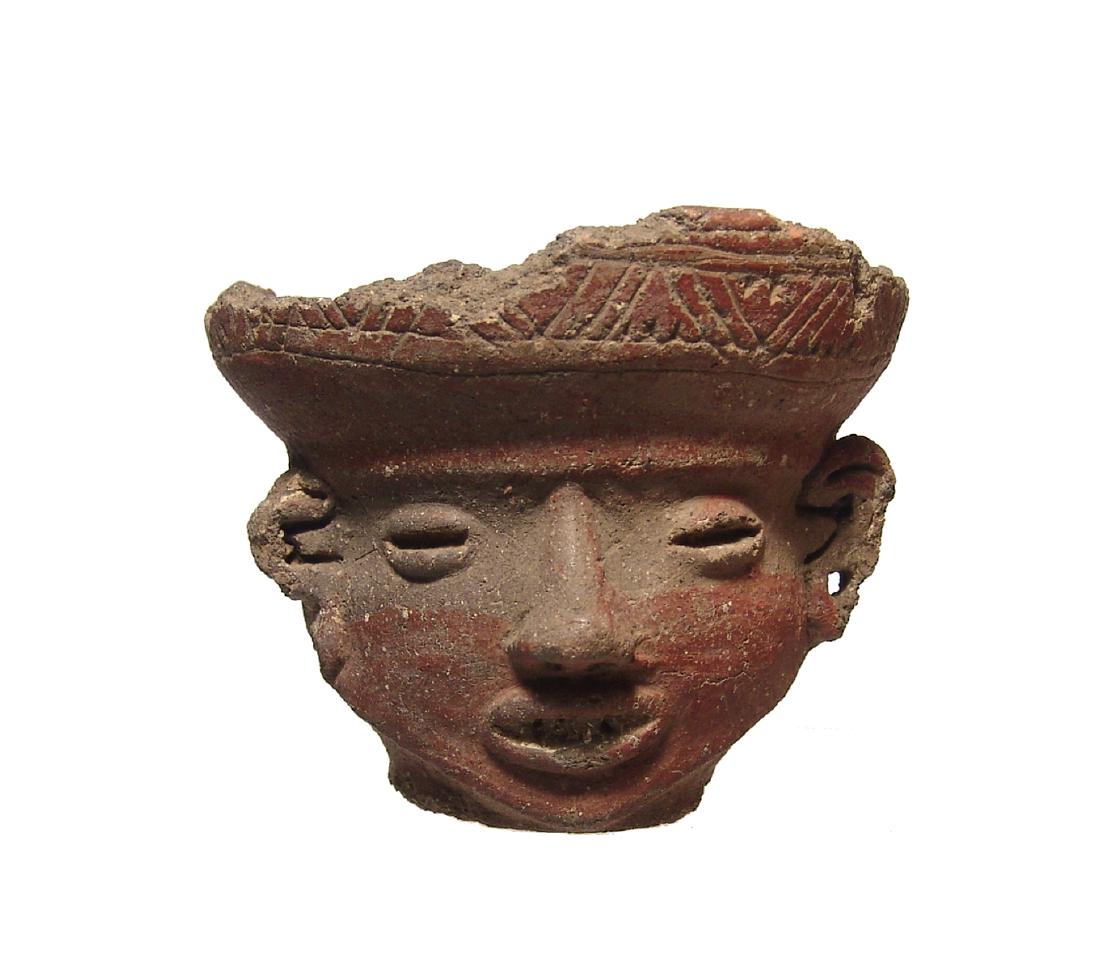 A Tarascan ceramic rattle head vessel, Mexico: A Tarascan ceramic rattle head vessel, Mexico, c. AD 1000 - 1500, with well-modeled features and wearing ear spools, a shallow bowl sits atop his head, the exterior of which nicely incised with geomet
