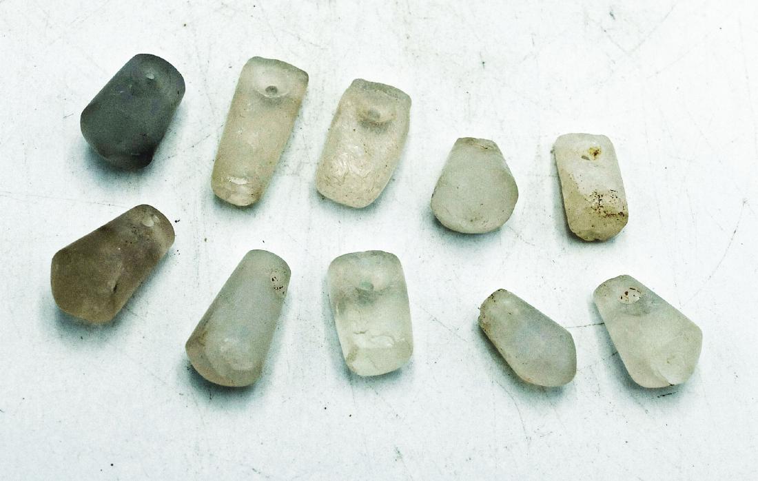 Group of 10 Tairona crystal pendants from Colombia: A choice group of 10 Tairona crystal pendants from Colombia, c. AD 1000 - 1500, each carved from translucent, polished quartz crystal. L: 1/2 to 7/8 in (1.3 to 2.3 cm). Ex New World Artifacts gallery.