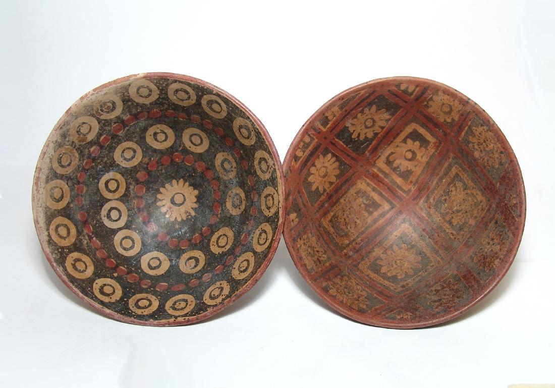 A pair of colorful Narino pedestal bowls, Colombia: A pair of colorful Narino pedestal bowls, Colombia, c. AD 1250 - 1500, each with beautiful floral and geometric decoration inside and out in red & black slip decorated with floral patterns. 3 3/4 x 7 