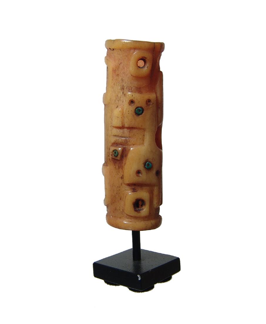 A lovely Huari bone handle with reptile and bird: A lovely Huari bone handle, c. AD 650 - 800, featuring a reptile in relief and a bird in profile, each accentuated with inlaid greenstone beads, rounded collar at either end. 2 7/8 in (7.3 cm). Well-p