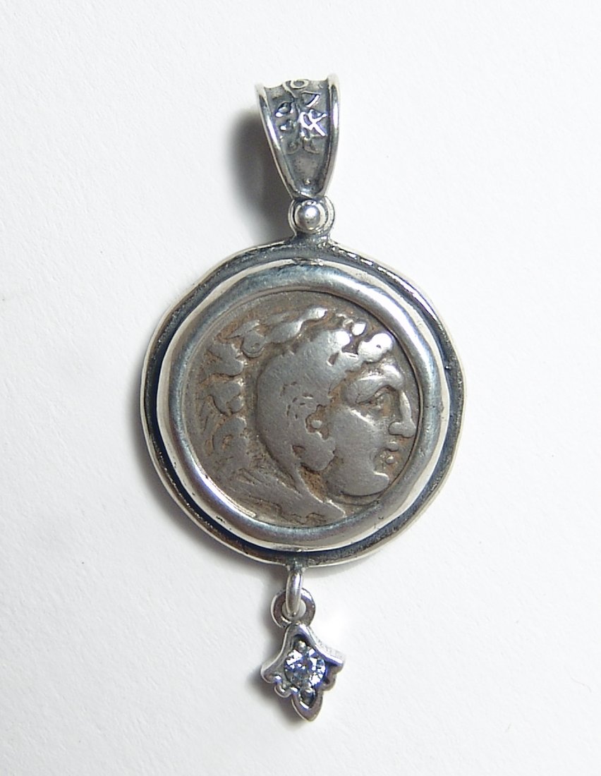 A silver pendant with Alexander the Great coin: A silver pendant with Alexander the Great coin. The coin was struck under Alexander the Great, King of Macedonia, 336 - 323 BC set into a lovely custom .925 silver bezel. The coin features the head of