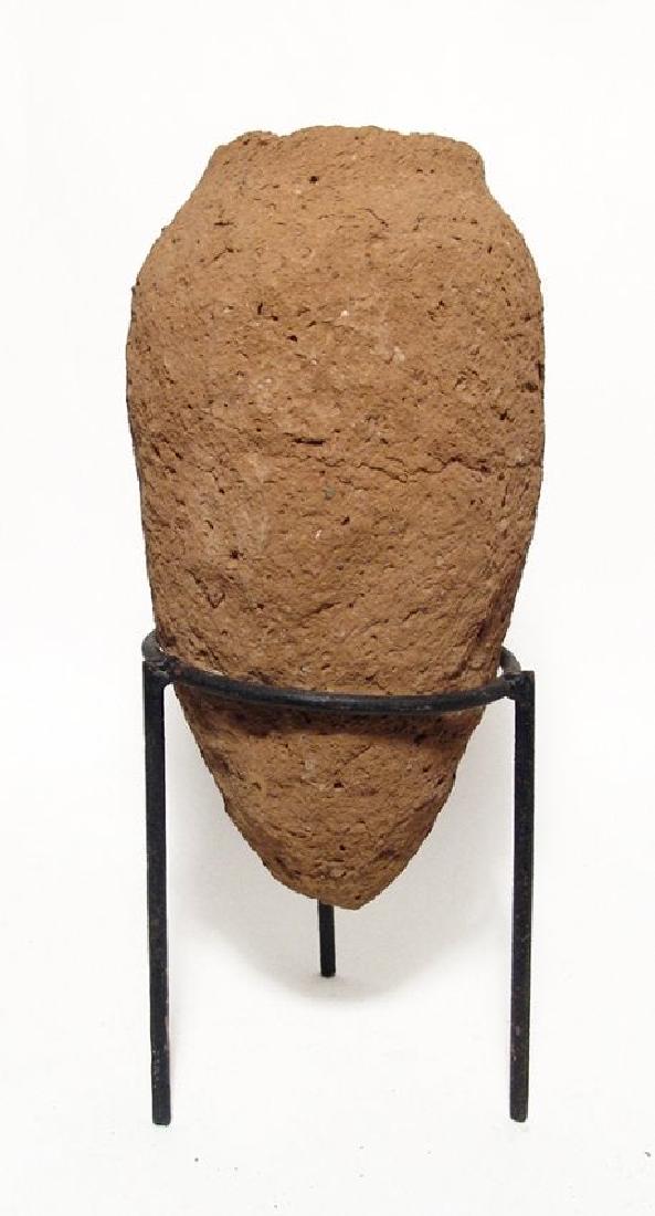 A large Egyptian Predynastic clay vessel: A large Egyptian Predynastic clay vessel, c. 3300 - 3000 BC, conical with pointed bottom, light shoulders and tall rim. H: 10 3/4 in (27.4 cm). The surfaces are heavily weathered. Custom metal stand.