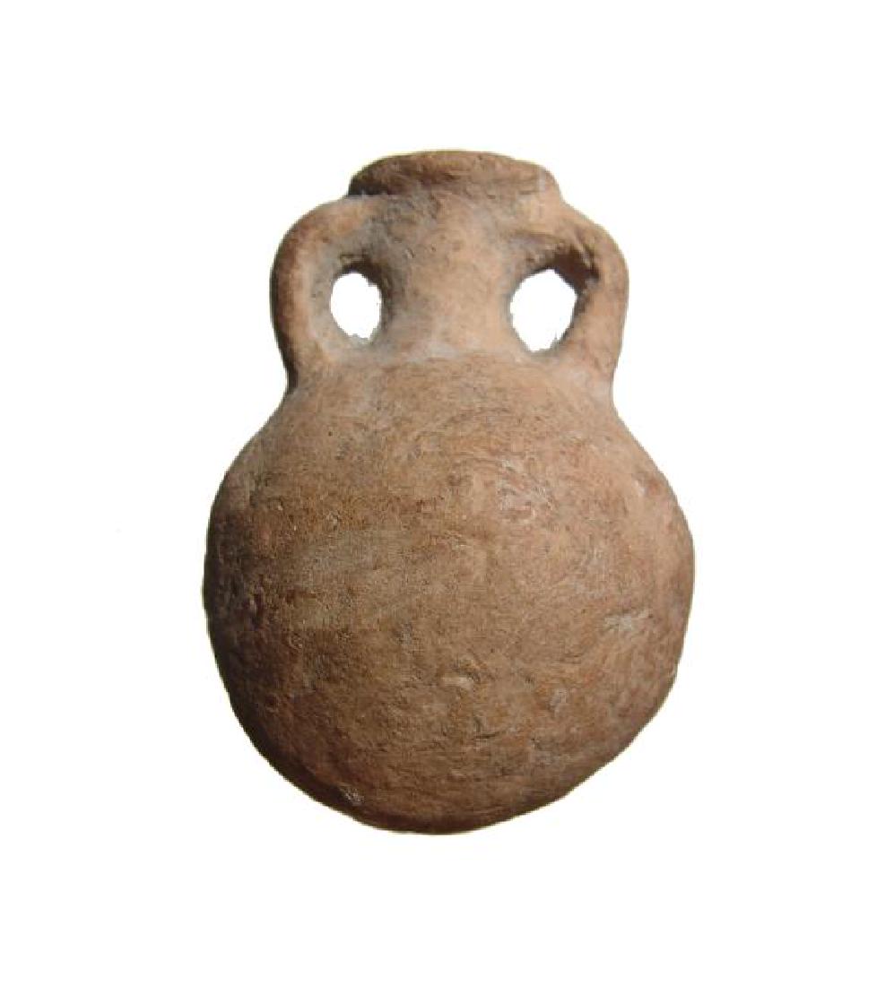An attractive Egyptian terracotta flask: An attractive Egyptian terracotta flask, c. 4th - 7th Century AD, with rounded body, narrow neck flanked by loop handles and widely flared mouth. H: 7 cm. Light deposits. Ex Derbyshire, UK private col