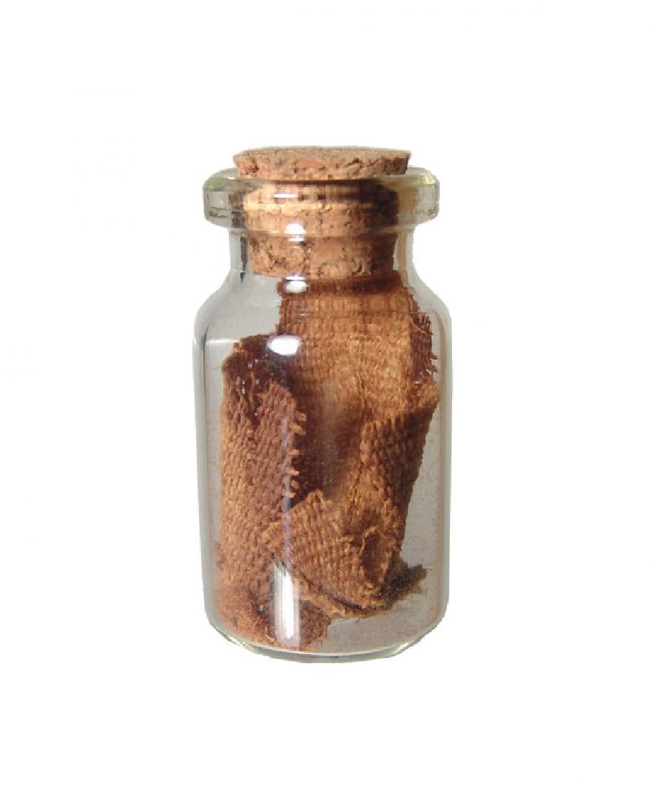 Bottle of Egyptian linen mummy-wrappings: A bottle of mummy-wrappings dating from Egypt's Third Intermediate Period c. 900-700 BC. Bottle H: 4 cm (1 5/8 in). Tan to brown color, recovered from a sarcophagus owned by BC Antiques Gallery (Los A