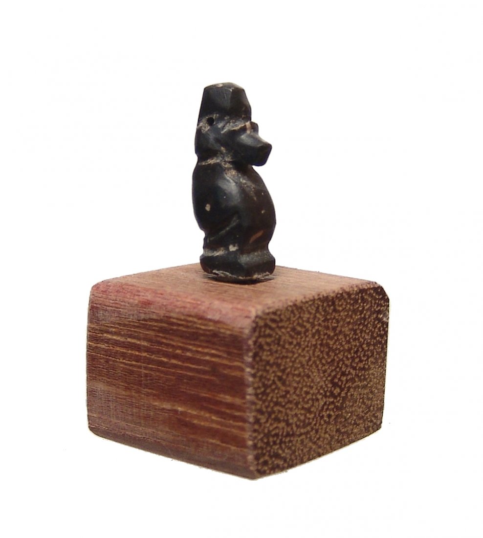 A nice Egyptian black serpentine amulet of a baboon: A nice Egyptian black serpentine amulet of a baboon, Late Period, c. 664 - 332 BC, representing the god Thoth seated on an integral base, the head nicely modeled and surmounted by a suspension loop. H