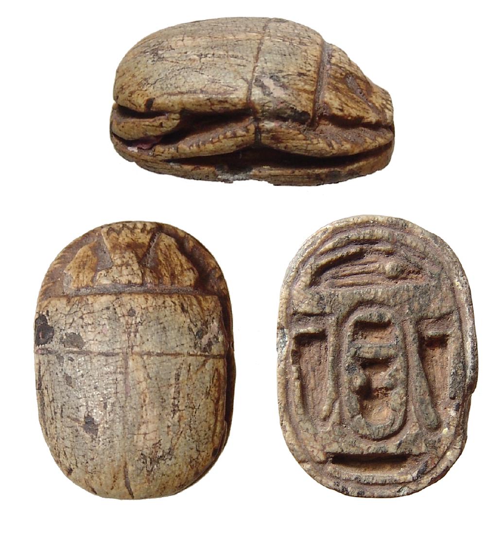 A large Egyptian steatite scarab, Thutmose III: A large Egyptian steatite scarab with cartouche, Later New Kingdom, c. 1200 - 1075 BC, the body and legs well-carved, on base an amuletic cartouche of 18th Dynasty pharaoh Thutmose III flanked by erec