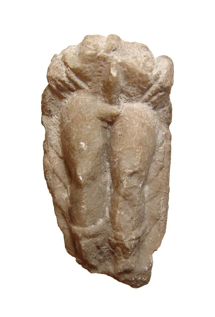 A Roman marble fragment of Priapus: A Roman marble fragment of Priapus, c. 2nd - 3rd Century AD, the lower portion of his figure remains depicting his classic pose of raising his robes to show his erect phallus. He wears detailed boot a