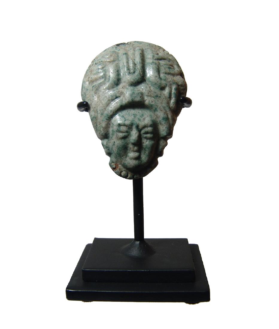 A beautiful Mayan jade head pendant: A beautiful Mayan jade head pendant, c. AD 600 - 800, with finely executed facial detail and wearing a beaded necklace and earspools. The elaborate headdress is tall and domed, the decoration comprise
