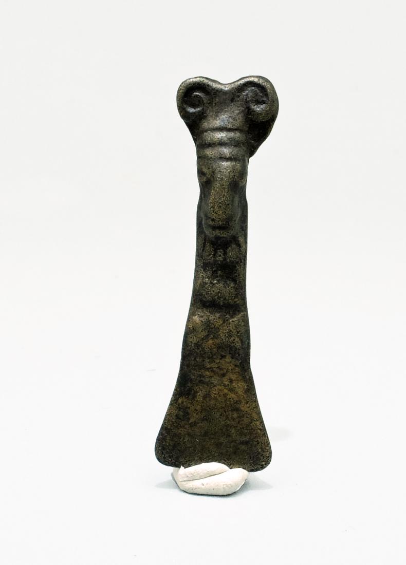 A fine Inca copper amulet: A fine Inca copper amulet, c. AD 1300 - 1500, depicting a deity with a large curled headdress. L: 1 3/4 in (4.4 cm). Intact suspension loop, well-worn patina. Ex New World Artifacts Gallery.