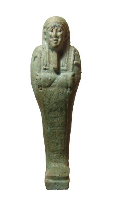 An Egyptian pale-green glazed faience ushabti: An Egyptian pale-green glazed faience ushabti, Late Period, c. 664 - 332 BC, mummiform, wearing striated tripartite wig with false beard, arms folded at chest and holding a pick and hoe, bag over left