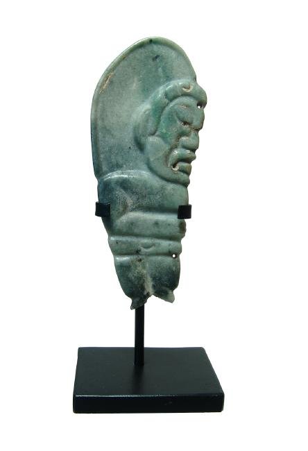 A beautiful Olmecoid jade pendant: A beautiful Olmecoid jade pendant, c. 200 BC - AD 250, carved from beautifully colored stone and with two perforations to be worn with the figure looking upward, the face nicely detailed and right han