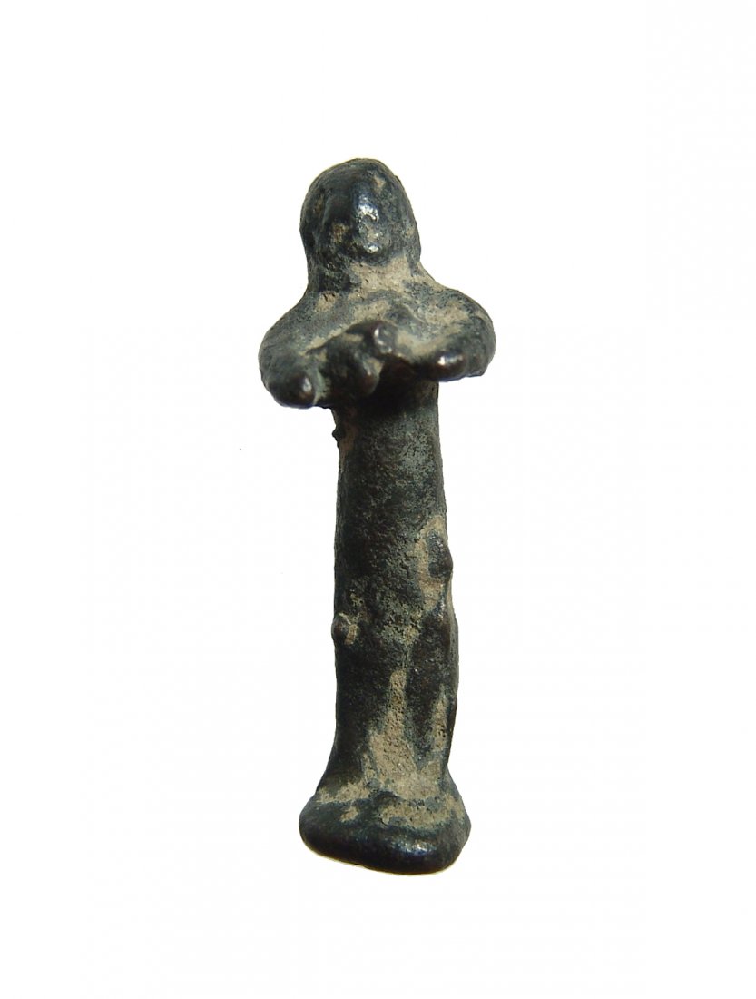 A Near Eastern bronze votive figure: A Near Eastern bronze votive figure, c. 1st Millennium BC, rather crude with integral base, columnar body and arms crossed at chest. H: 1 7/8 in (4.8 cm). Nicely patinated. Ex Detroit private collecti