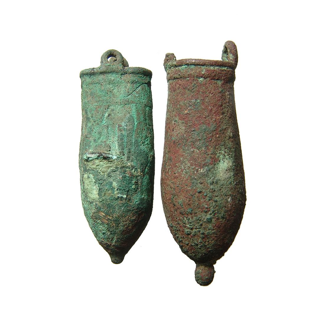 A pair of Egyptian bronze situlas, Late Period: A pair of Egyptian bronze situlas, Late Period, c. 664 - 332 BC, one with a deformity, likely from its manufacture, and remains of a scene involving standing deities around the outside. Largest H: 3 1