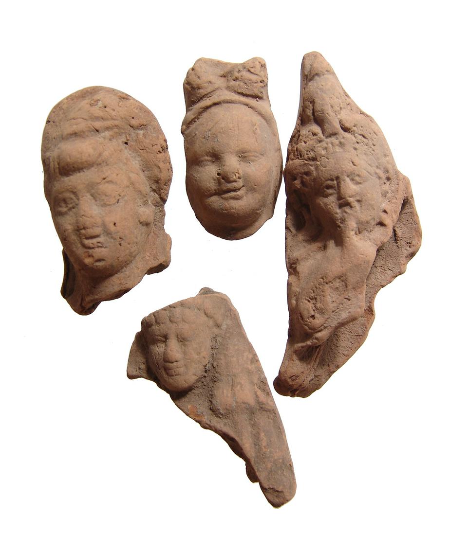 A lot of 4 Romano-Egyptian terracotta heads: A lot of 4 Romano-Egyptian terracotta heads, c. 1st - 2nd Century AD, two are heads of Harpokrates, one with finger to mouth, and the other two are male heads. Each is nicely detailed and a good examp