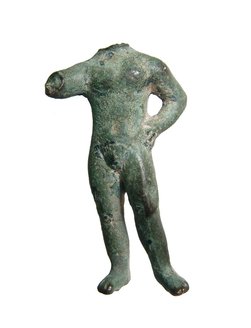 A Roman bronze figure of a man: A Roman bronze figure of a man, c. 1st - 3rd Century AD, sans head and right arm, bust standing nude with remaining left hand on hip. H: 2 3/4 in(6.8 cm). Attractively patinated. Ex English private co