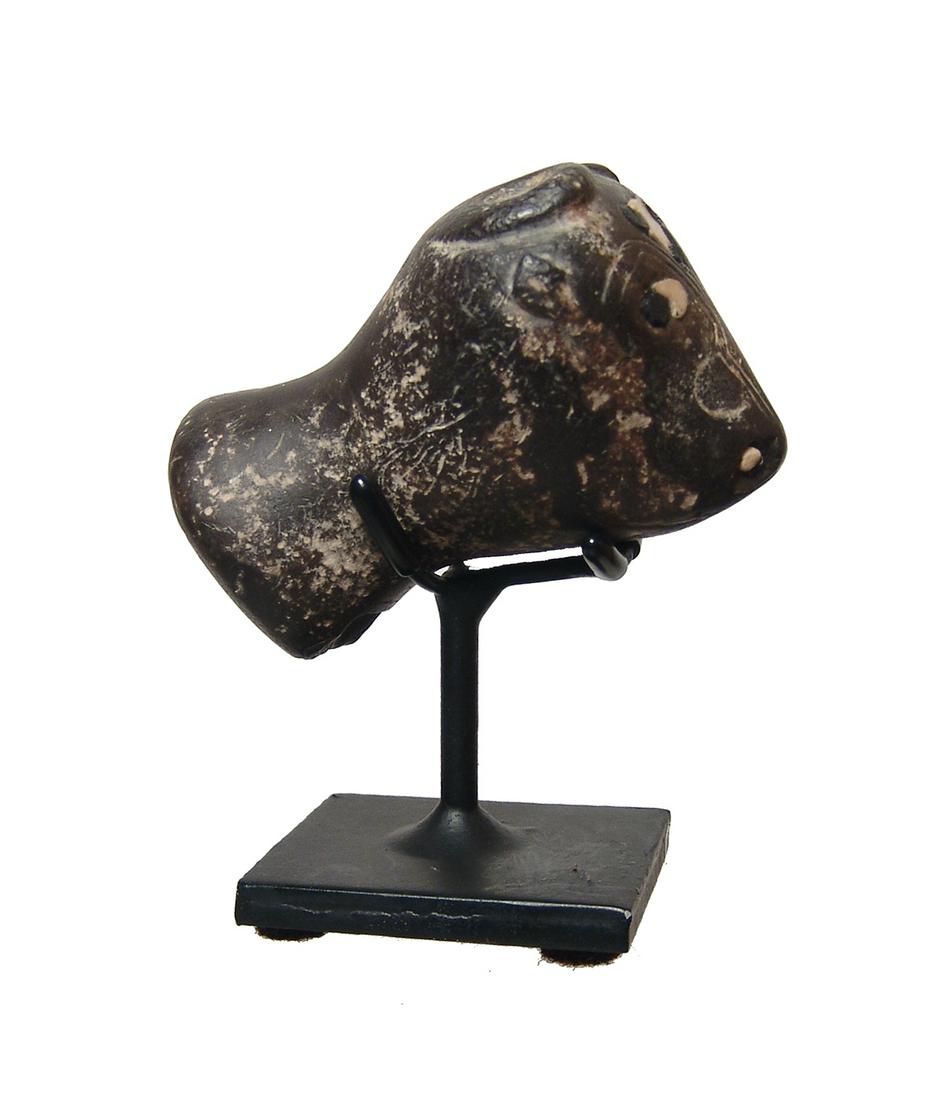 A wonderful Sumerian carved stone head of a bull: A wonderful Sumerian carved stone head of a bull, early 3rd Millennium BC, with curved horns atop the head and incised decoration on either side of the snout. The base of the neck rounded, presumably 