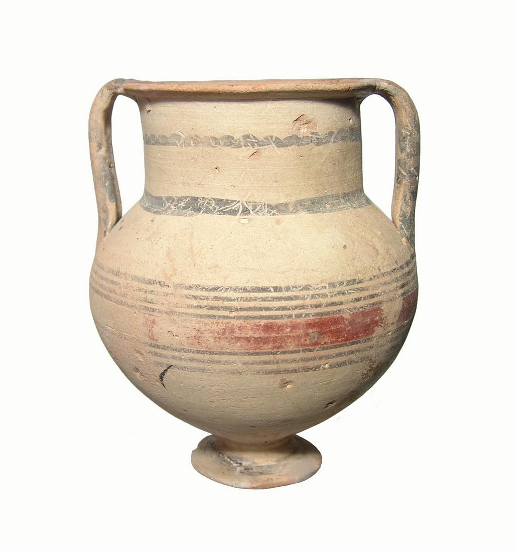 A large footed Cypriot bi-chrome amphora: A large footed Cypriot bi-chrome amphora, c. 750 - 600 BC, on a low pedestal foot, the vessel adorned with horizontal bands in brown slip around the mid-body, neck and the handles. Inside the rim are 