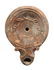 A Roman ceramic lamp with a laurel wreath