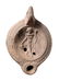 A Roman ceramic lamp with Dionysus within the discus