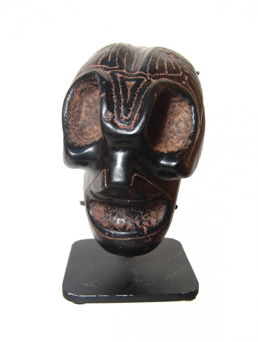 A very neat Taino magnetite Alien looking head: A very neat Taino magnetite 'Alien' looking head, c. AD 1000 - 1500, with highly modified brow ridge and narrow jaw line, likely characterizing a shamanic spiritual transition. Forehead fully engraved