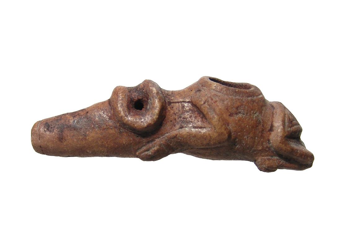 A nice Taino personal snuffing vessel: A nice Taino personal snuffing vessel, c. AD 1000 - 1500, made from a brown metamorphic stone. The long nosed reclining zoomorphic cohoba inhaler with central bowl at the back, the front legs run from