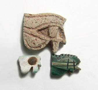 A group of 3 Egyptian 'Eye of Horus' amulets: A group of 3 Egyptian 'Eye of Horus' amulets, 3rd Intermediate - Late Period, c. 1075 - 332 BC, the largest with recessed detail, 24 x 20 mm, a green glazed carved steatite example, 16 x 12 mm, and