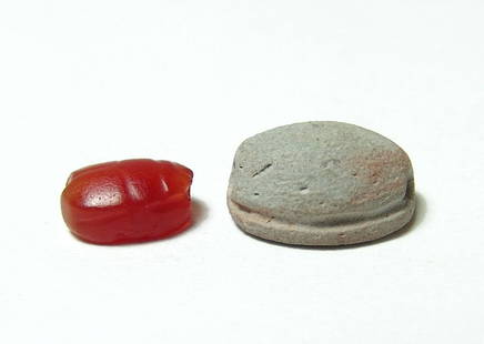 A pair of Egyptian scarabs, New Kingdom: A pair of Egyptian scarabs, New Kingdom, c. 1570 - 1075 BC, the first a lovely carnelian example carved in nice quality stone with an incised star on the base, 13 x 11.5 mm, the second a faience