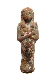 Egyptian ceramic ushabti, 3rd Intermediate Period: An Egyptian ceramic ushabti, 3rd Intermediate Period, c. 1075 - 664 BC, depicted mummiform, wearing tripartite wig, arms folded over chest, hands grasping a pick and hoe, bag painted at center of