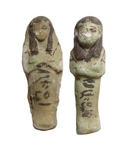 Egyptian faience ushabtis, 3rd Intermediate Period: A pair of Egyptian faience ushabtis, 3rd Intermediate Period, 21st Dynasty, c. 1080 - 945 BC, each mummiform, wearing tripartite wig, arms folded at chest and holding a pick and hoe. Each is bicolor