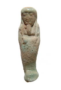 Egyptian pale-blue faience ushabti, Late Period: An Egyptian pale-blue faience ushabti, Late Period, c. 664 - 30 BC, depicted mummiform, wearing tripartite wig and false beard, arms folded across chest and holding a pick and hoe. L: 3 1/8 in (7.9