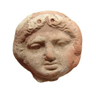 Greek terracotta roundel depicting face of a Gorgon