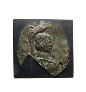 A Roman bronze applique depicting a Minerva: A Roman bronze applique depicting a Minerva, c. 1st - 4th Century AD, fashioned in repousse in sheet bronze. The goddesses bust is depicted in profile wearing a crested helmet and aegis,