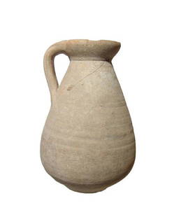 A nice Roman ceramic pitcher: A nice Roman ceramic pitcher, c. 1st - 3rd Century BC, the elongated piriform body with disk foot, the neck narrows with flared rim and strap handle. The vessel is well-preserved with light surface