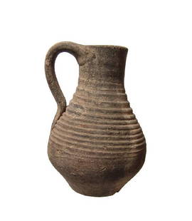 A Late Roman single-handled flask: A Late Roman single-handled flask, c. 4th - 5th Century AD, the body and neck decorated with horizontal grooves. H: 4 3/4 in (12.2 cm). Light surface deposits. An interesting and attractive form! Ex