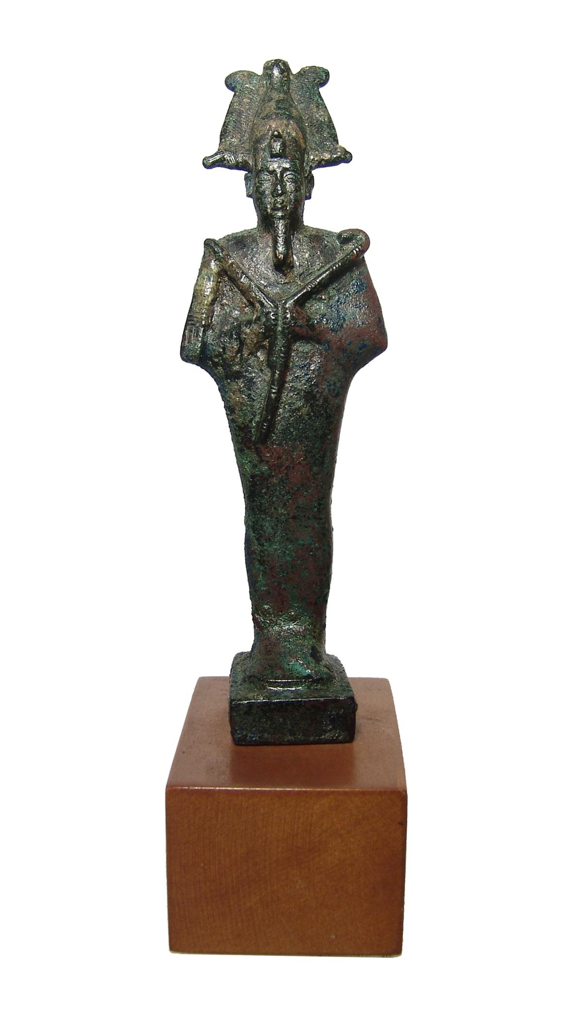 A stunning Egyptian bronze standing figure of Osiris: A stunning Egyptian bronze standing figure of Osiris, Late Period, c. 664 - 332 BC, mummiform, wearing Atef crown with uraeus and false beard, arms folded across chest, hands holding a crook and flail