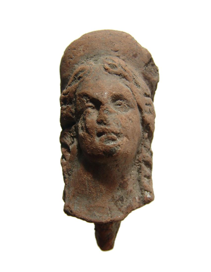 Graeco-Roman terracotta head of a goddess, Egypt: A well-detailed Graeco-Roman terracotta head of a goddess, Egypt, 2nd Century BC - 2nd Century AD, with attractive features and wearing a large rounded diadem; hair in long locks descending to her sho