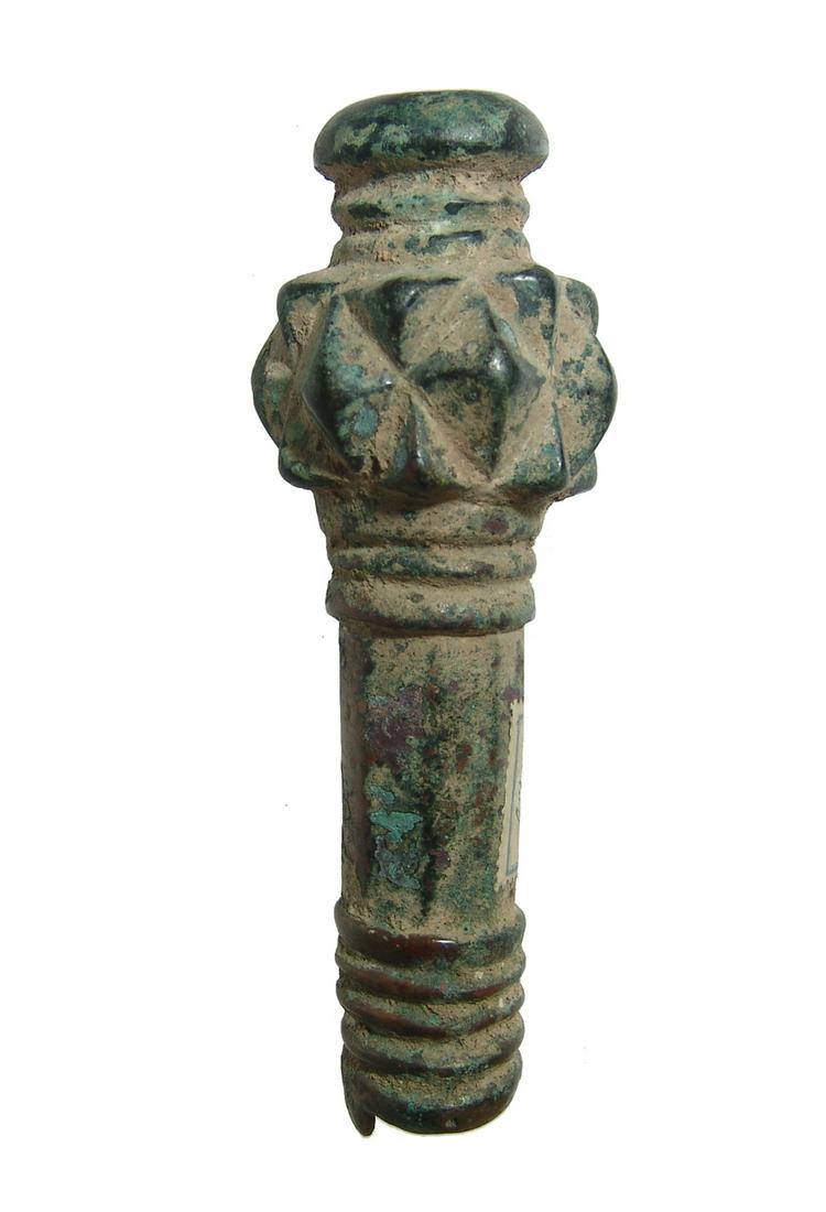 A pleasing Near Eastern bronze mace head: A pleasing Near Eastern bronze mace head, c. 1000 - 600 BC, with faceted knobs around the swollen head, the shaft with concentric grooves and topped with a collar. L: 6 1/8 in (15.5 cm). Nicely patina