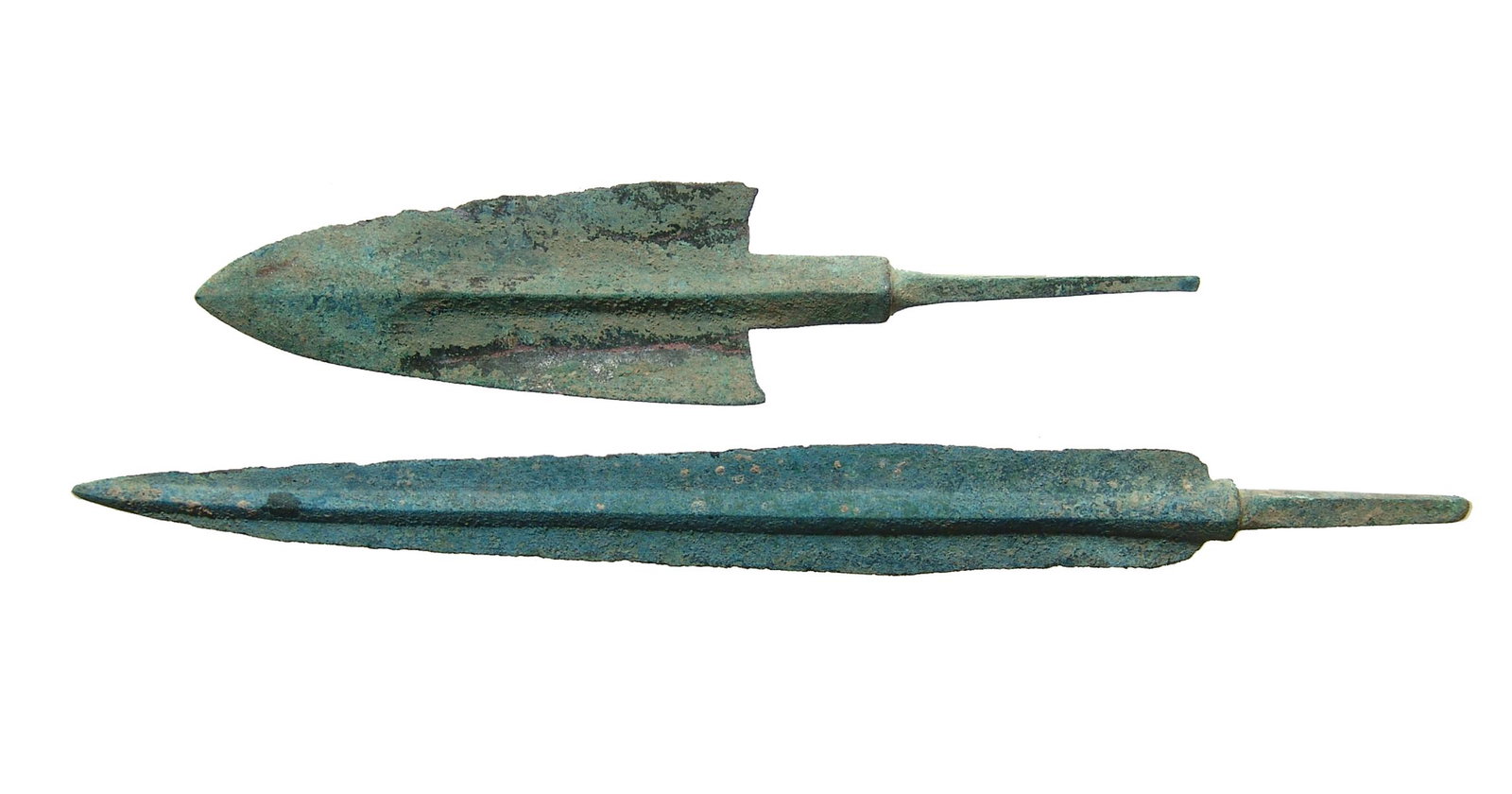 A pair of Near Eastern bronze weapon points: A pair of Near Eastern bronze weapon points, c. 1000 - 600 BC, the first a large arrow or ballista point with narrow blade, heavy midrib and long tang, L: 7 3/8 in (18.7 cm). The second an arrow point