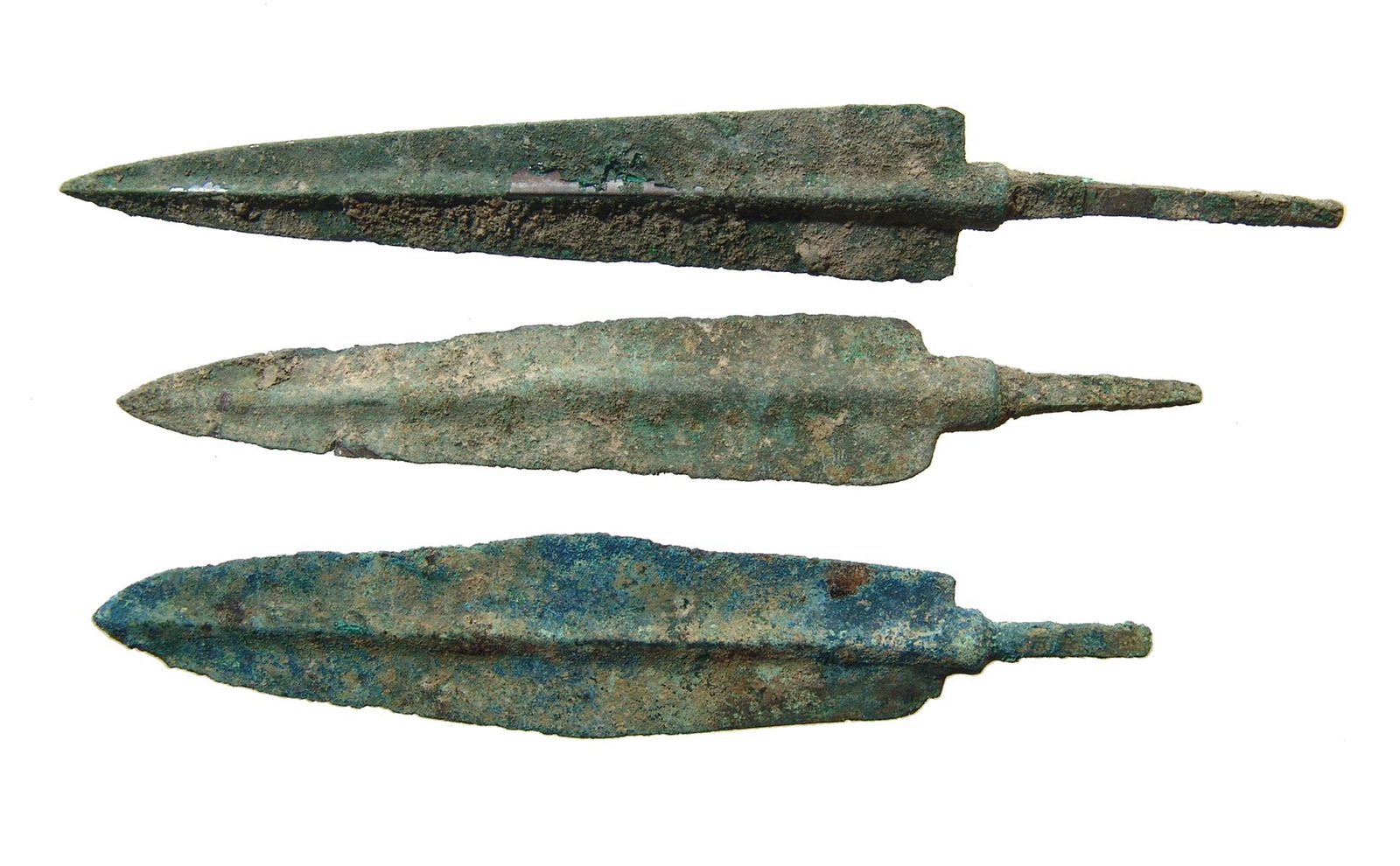 A group of 3 Near Eastern bronze weapon points: A group of 3 Near Eastern bronze weapon points, c. 1000 - 600 BC, two with triangular blades and one with leaf-shaped blade. All have pronounced midribs and long mounting tangs. Largest 5 3/8 in (13.7