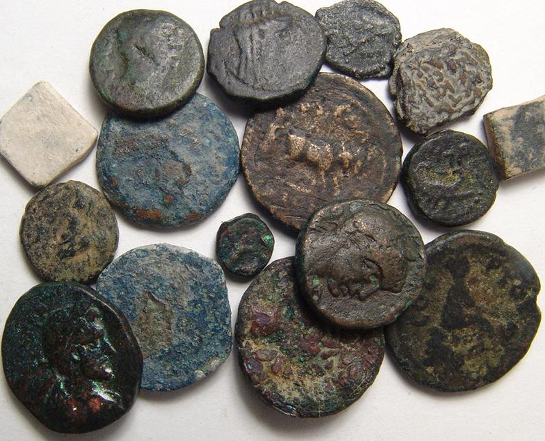 A group of 16 coins and weights from the Holy Land: A group of 16 coins and weights from the Holy Land. Lot includes examples from the Greek period, Roman Procurators of Judaea and Roman Imperial period. Two square lead weights are also from the Roman 