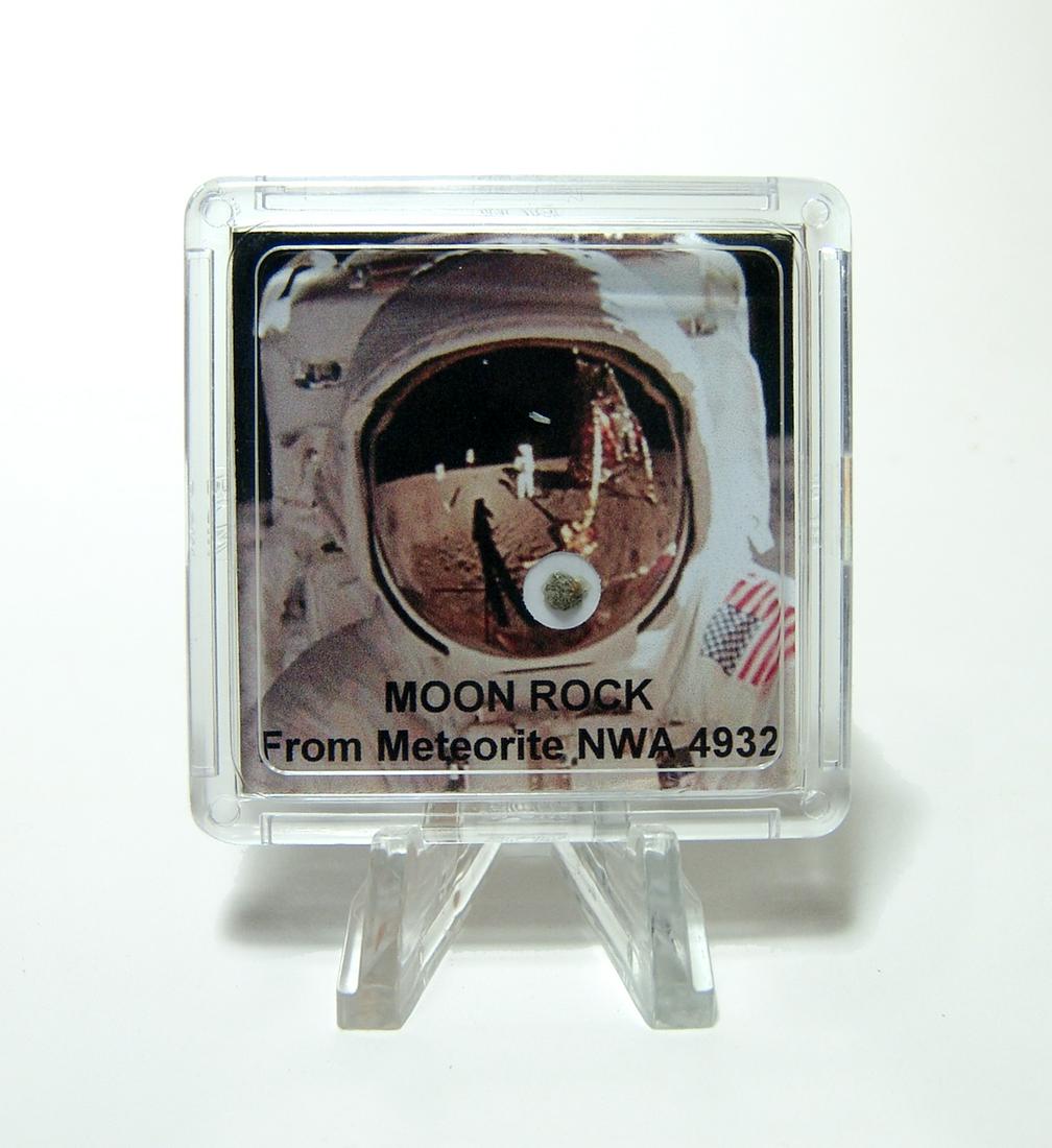 A fragment of moon rock in a display case: A fragment of moon rock in a display case. A fragment of lunar gabbro meteorite NWA 4932, which is part of a stone found in the Sahara Desert in 2007. The moon is regularly struck by meteorites which