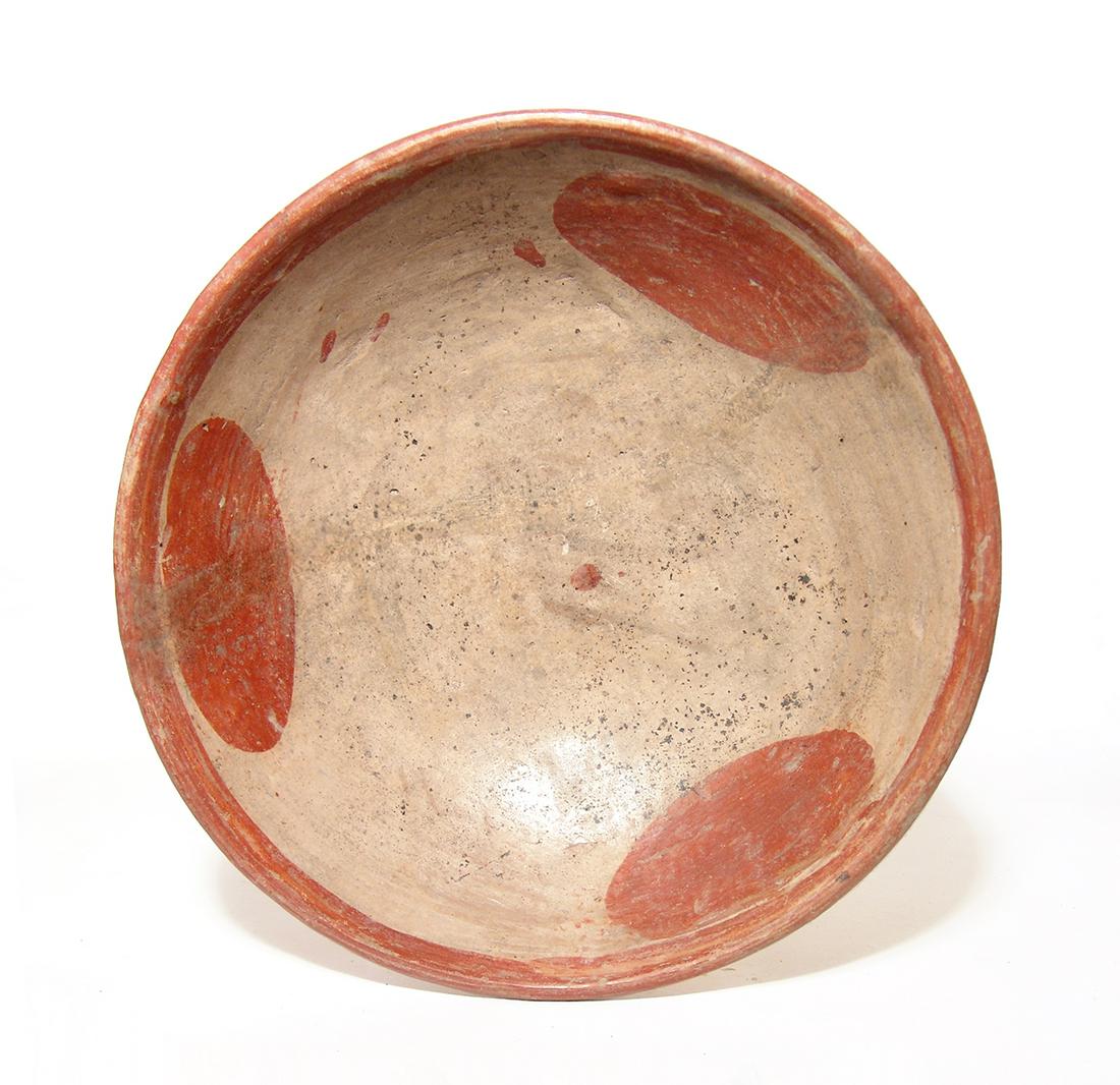 A large Nayarit Amapa Post-Classic bowl: A large Nayarit Amapa Post-Classic bowl, West Mexico, c. AD 900 - 1100, in red over buff, three large ovals float around a central dot in the interior with a solid band around the rim. H: 3 ½ in (8.9