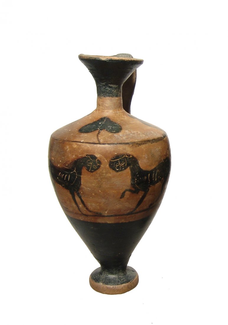 An Etruscan black-figure lekythos with pair of panthers: An Etruscan black-figure lekythos-type vessel, 6th Century BC, featuring a pair of facing panthers accented with incised detail. Around the shoulders are two standing robed figures and a grape leaf. H