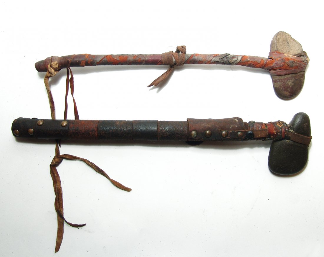 A pair of Native American stone axes, c. early 20th C.: A pair of Native American stone axes, c. early 20th Century. Each shows a lot of age and are comprised of a wood shaft with mounted stone heads. Each of the shafts are beautifully wrapped with leather